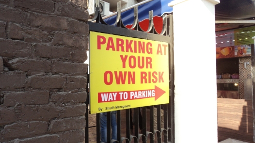 A sign board at the entrance of the main parking area.